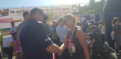 Na zdjęciu widać, jak Komendant Powiatowy Policji w Ostrzeszowie gratuluje zawodniczce pokonania dystansu
